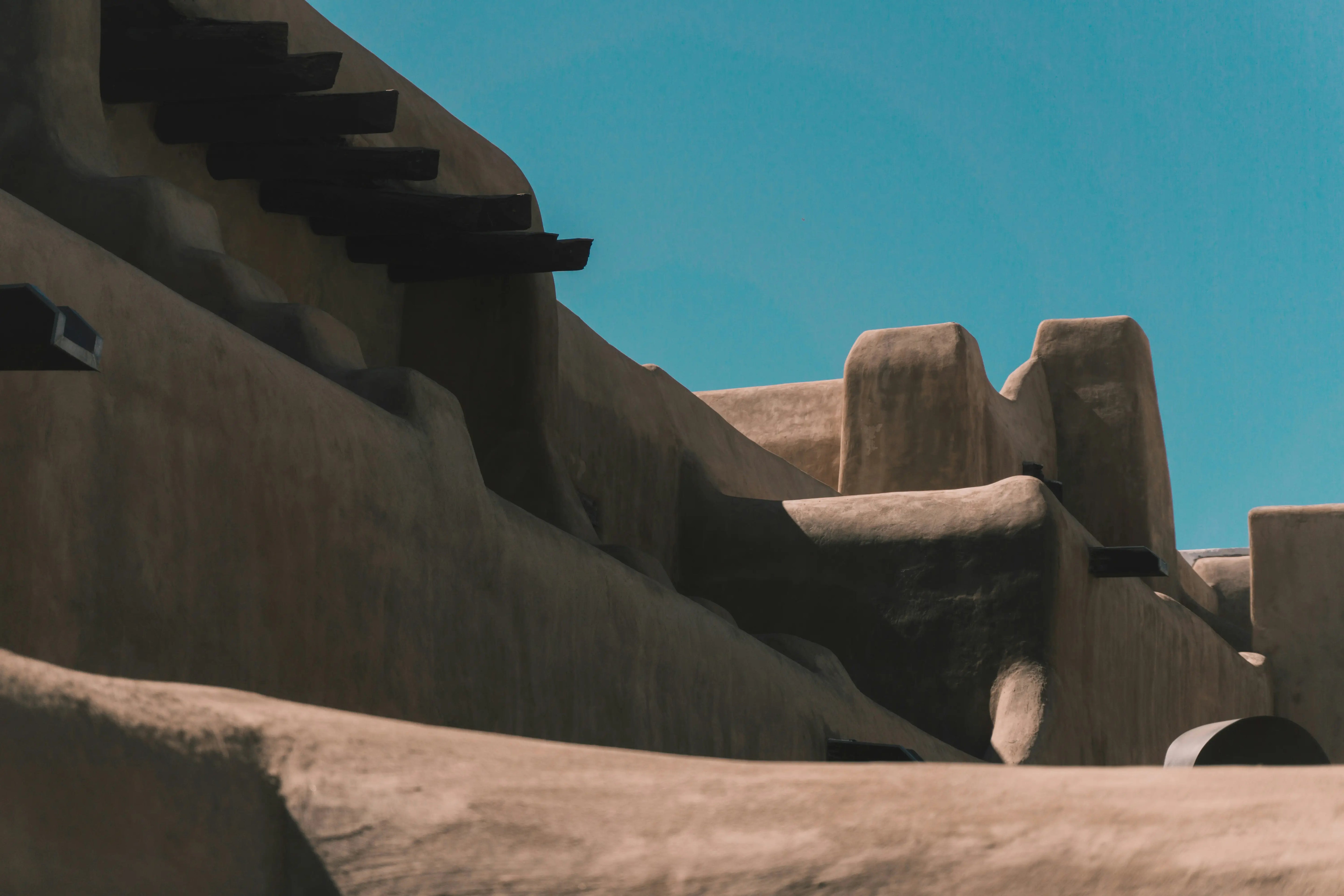 Traditional adobe architecture in Santa Fe, New Mexico with a clear blue sky