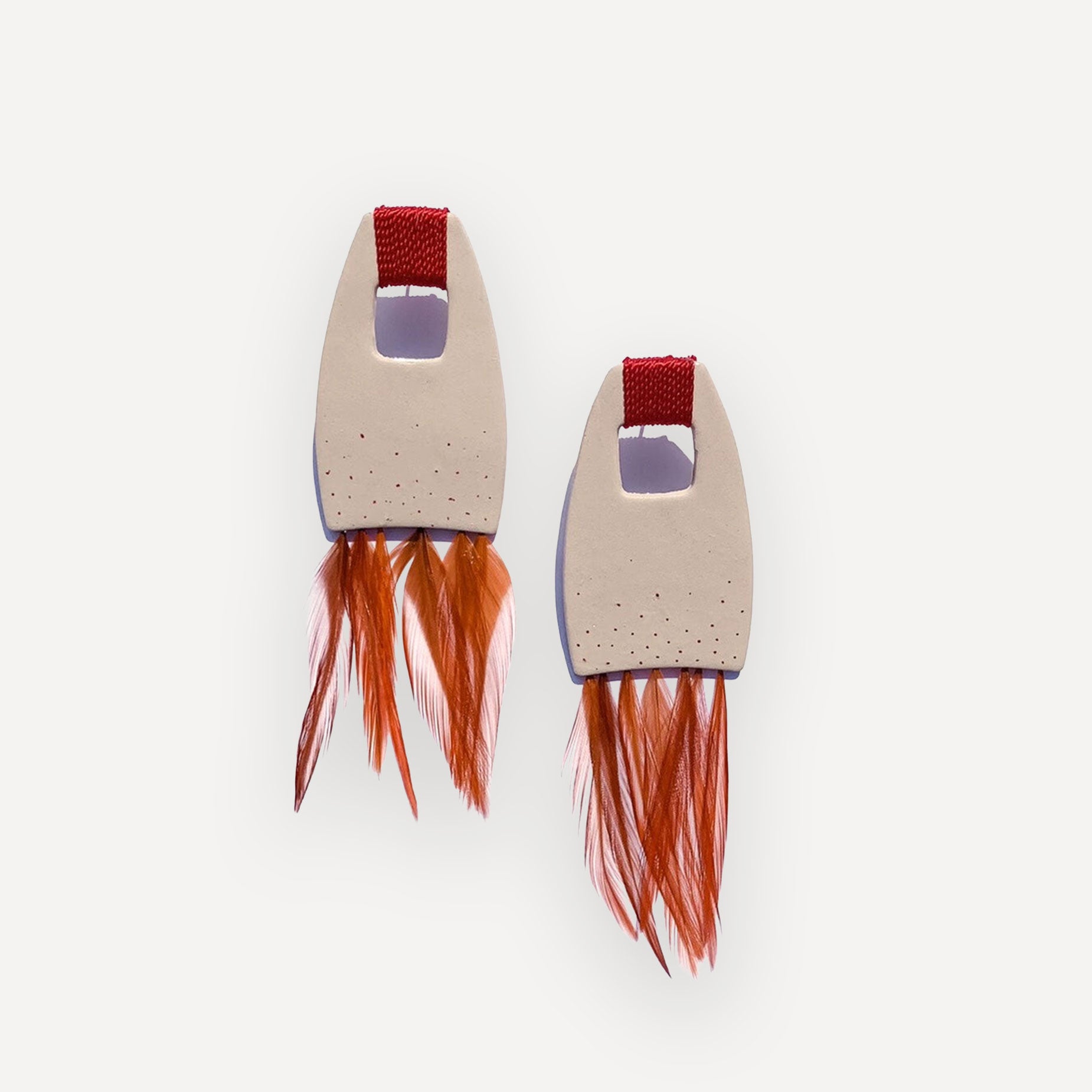Ceramic Earrings with red feather base on white background
