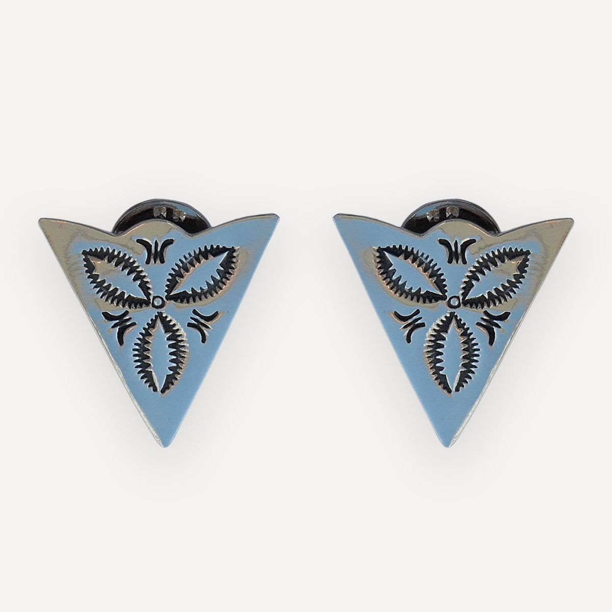 Pair of sterling silver collar tips with a full stamped bluebonnet blossom and curved accent stamps on a white background