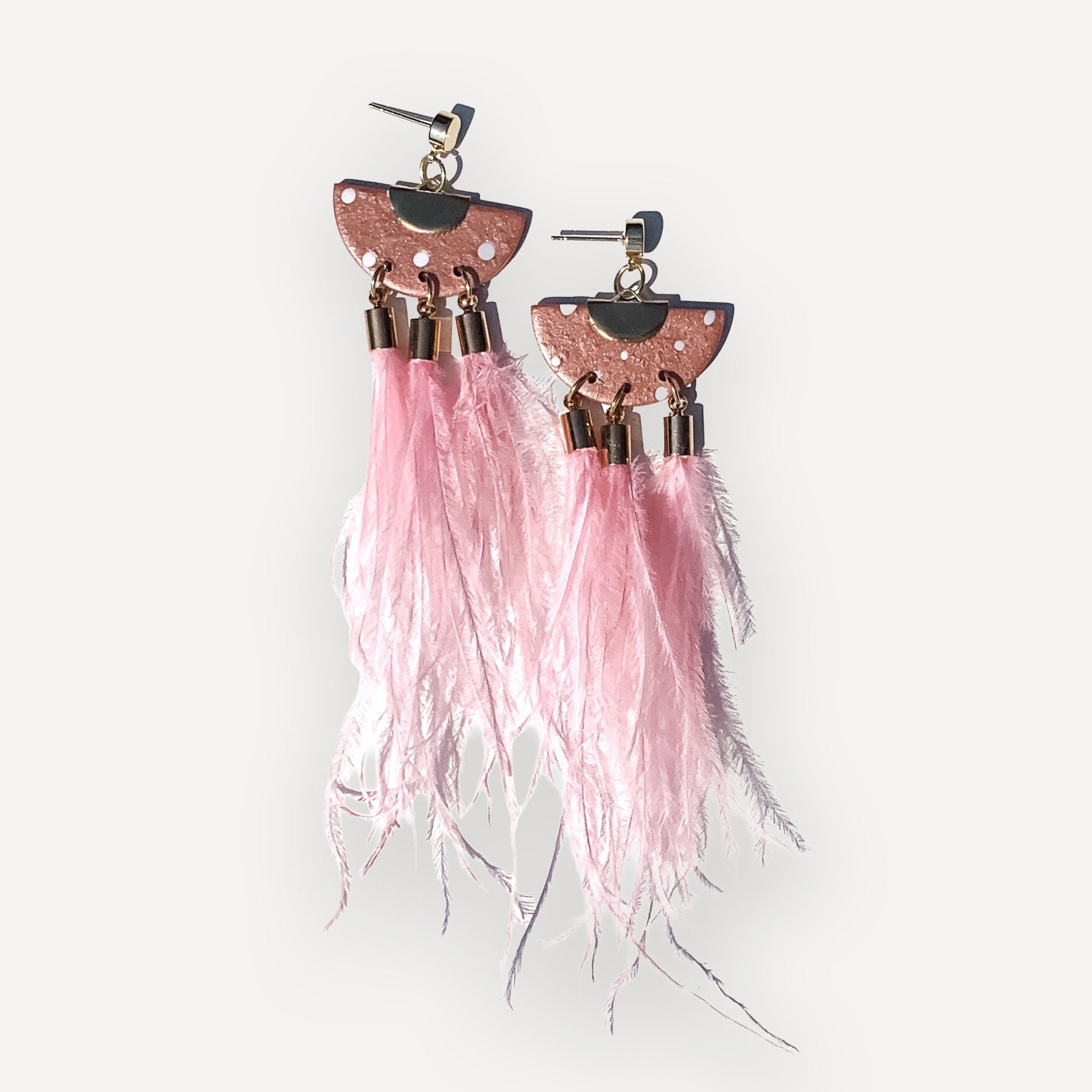 pink Clay and ostrich feather dangle earrings on white background