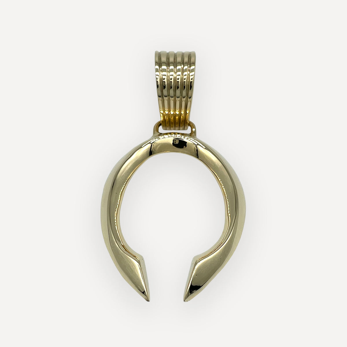 Gothic naja pendant sandcast in solid 18 karat gold with a fluted ingot bail on a white background