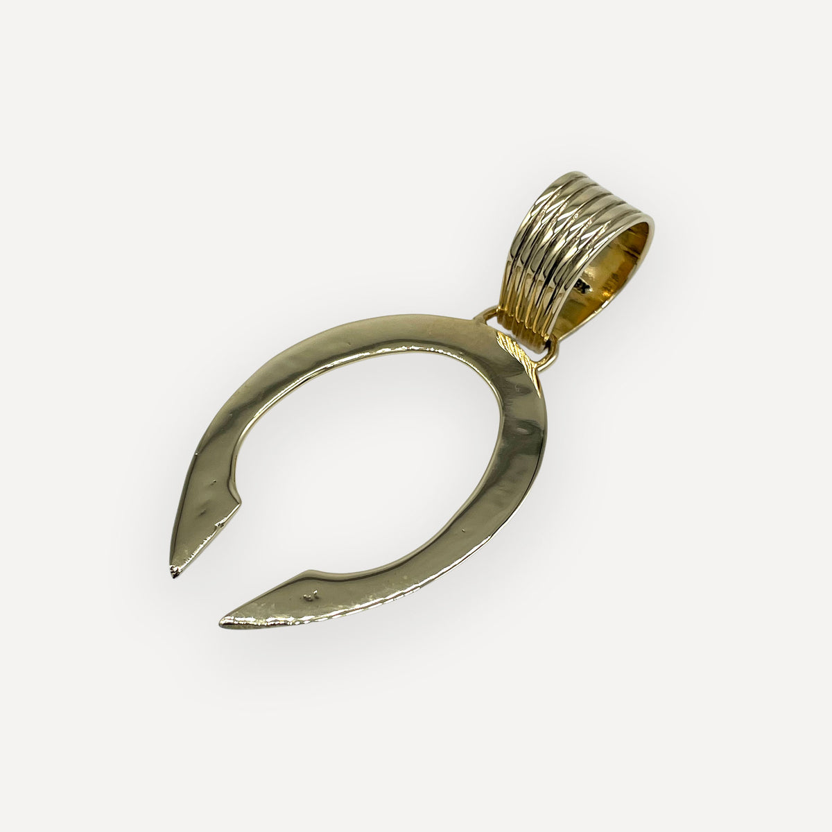 Front view of a solid 18 karat gold navajo naja pendant with open crescent design