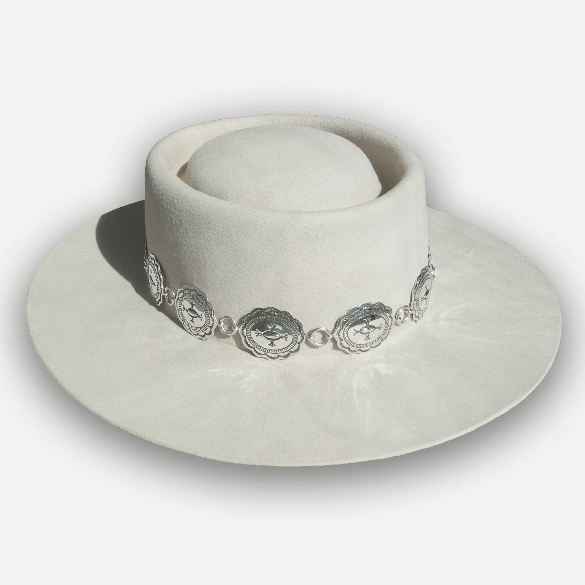 Texas Flood concho link hatband with stamped silver conchos shown on a white felt hat