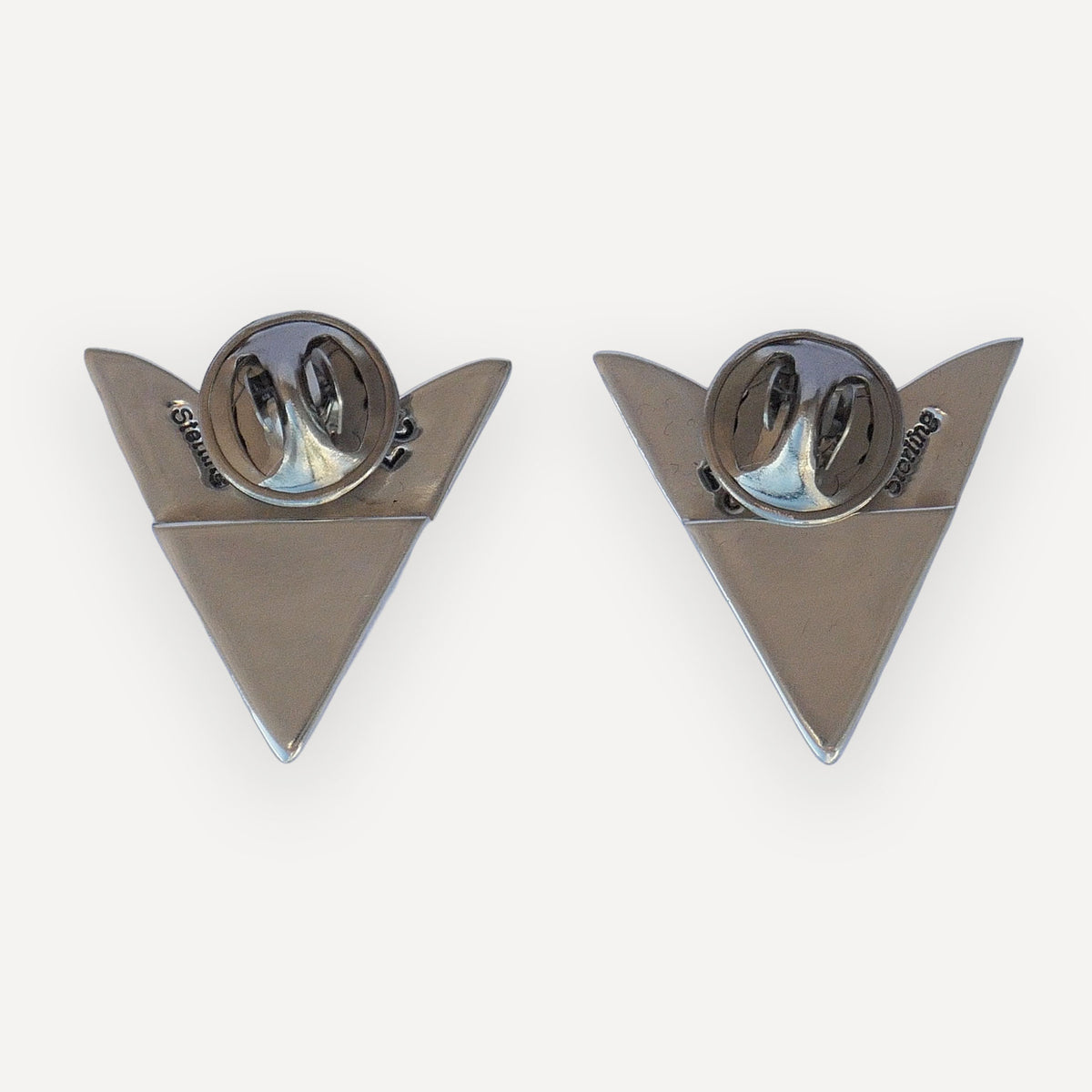 Back of two sterling silver indian paintbrush collar tips with Sterling and LC hallmarks and clutch pin backings