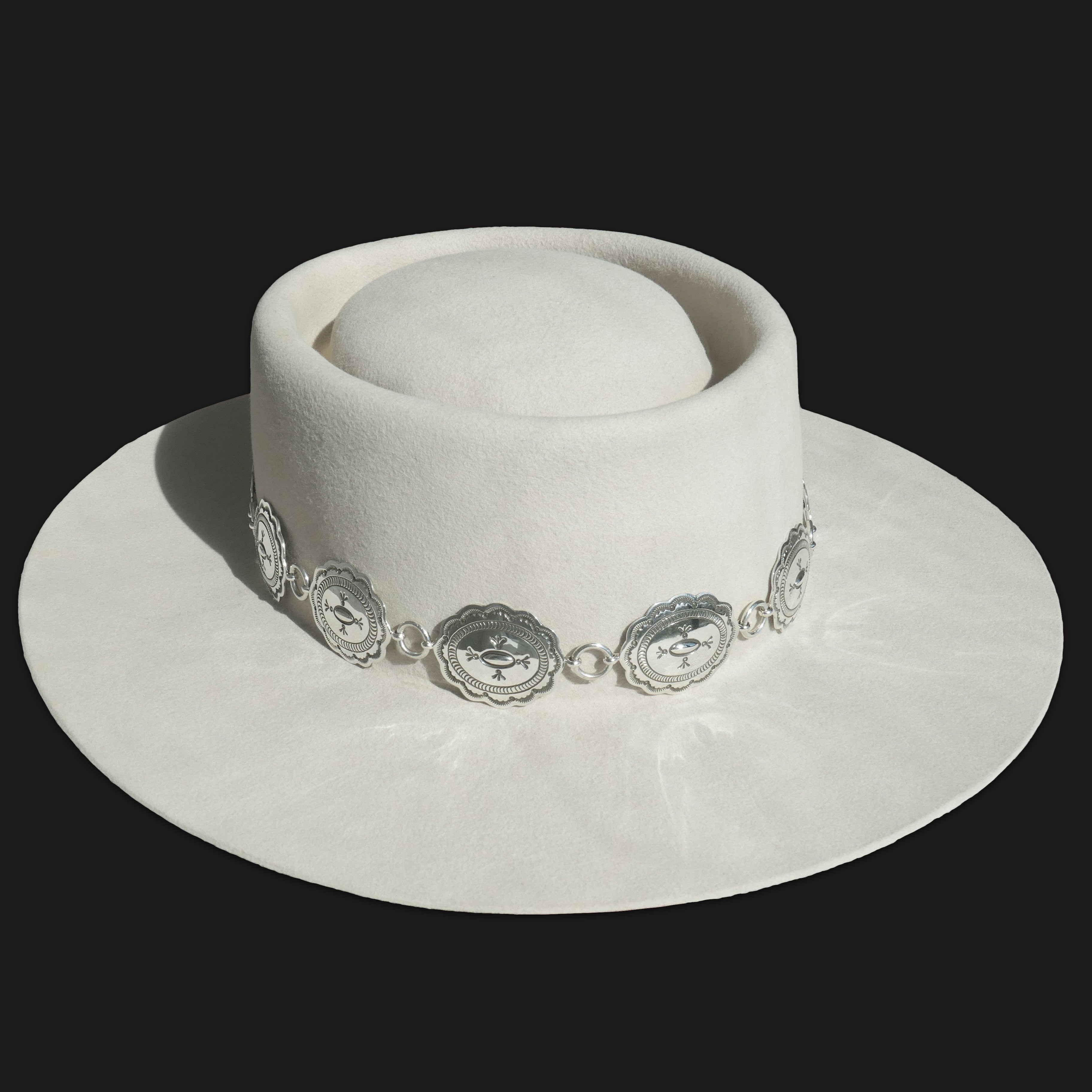 Texas Flood concho link hatband with stamped silver conchos shown on a white felt hat.