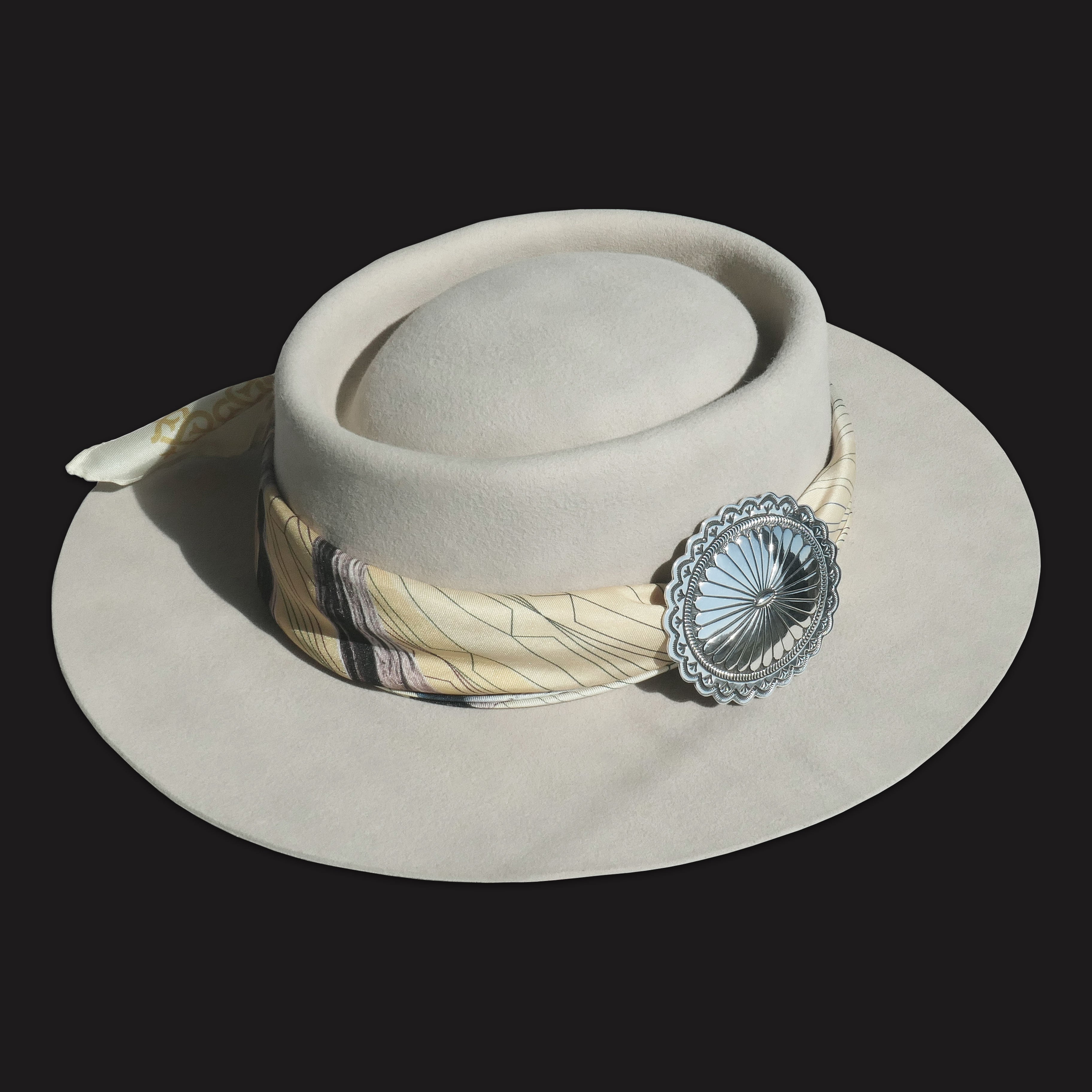 4 Corners Navajo concho scarf slide ring, sterling silver handstamped design, shown styling a silk scarf on a hat.