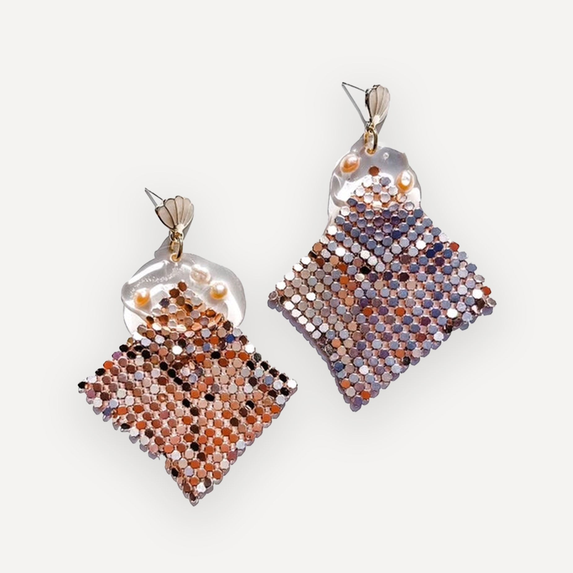 Pair of square disco pattern earrings with mosaic pattern on a white background