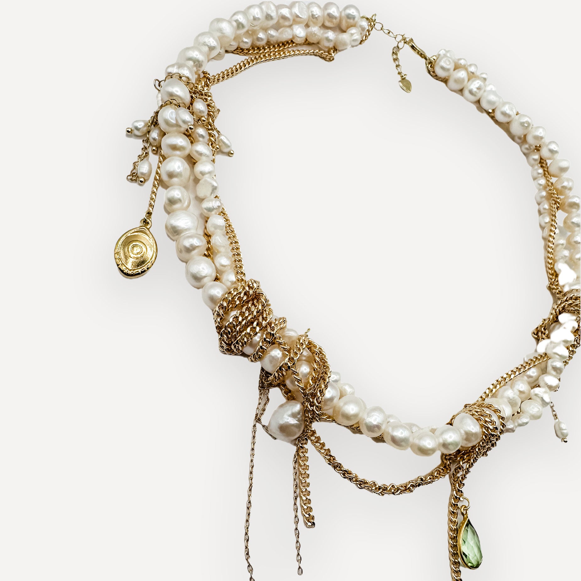 Gold and pearl necklace on a white background