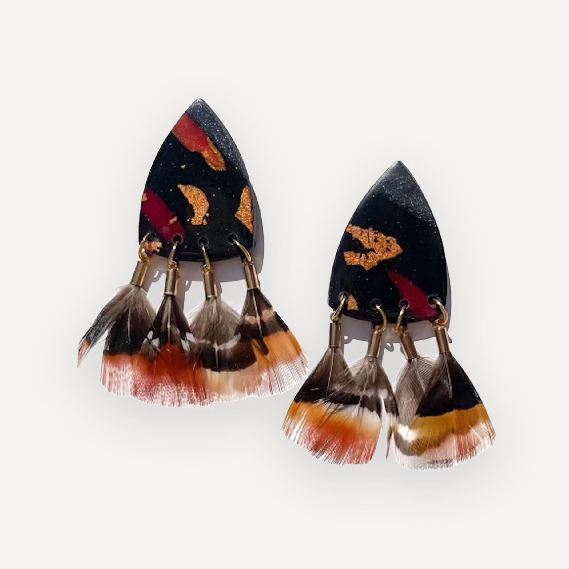 Black clay earrings with feather base on white background