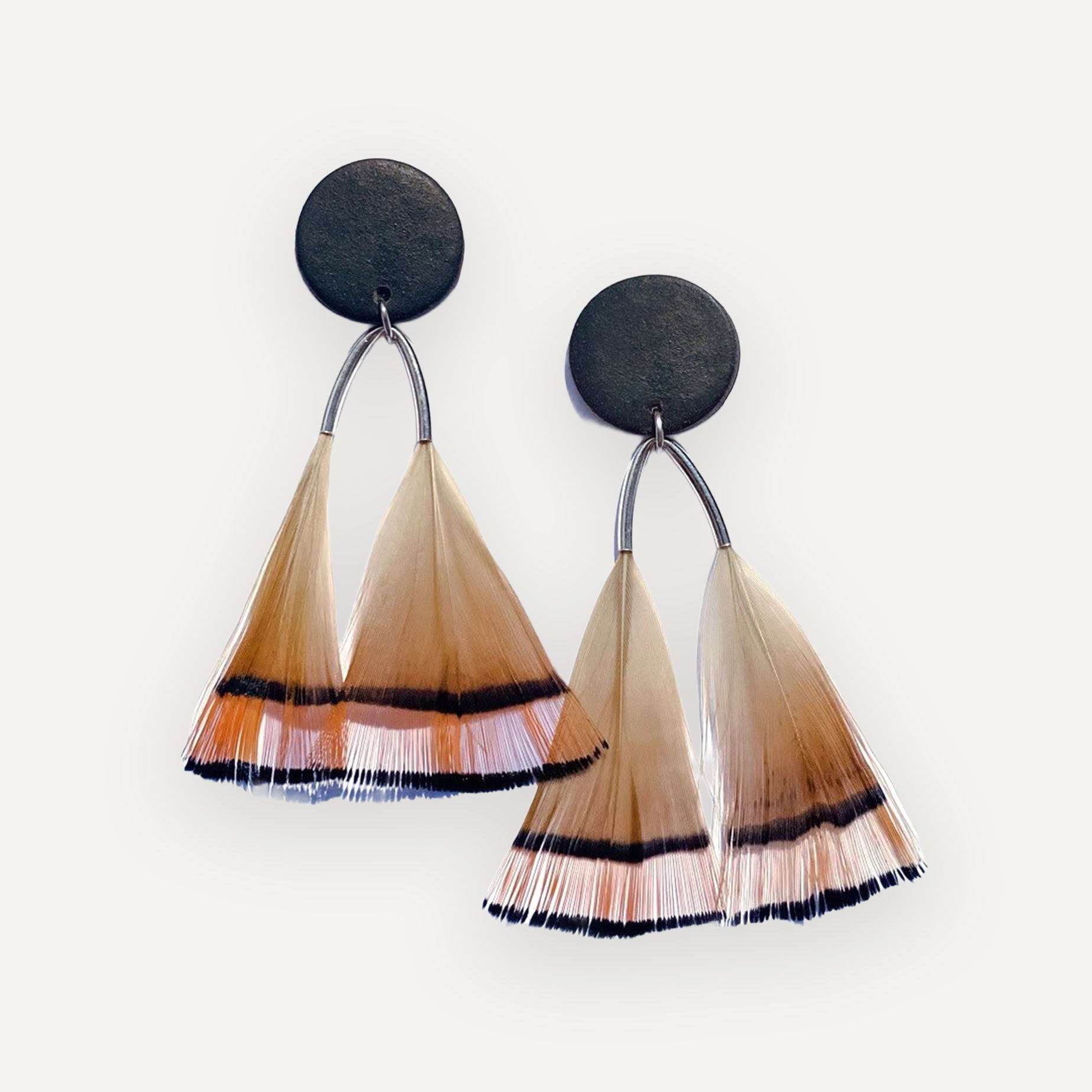 Pair of earrings with black, beige, and brown gradient fringes on a white background