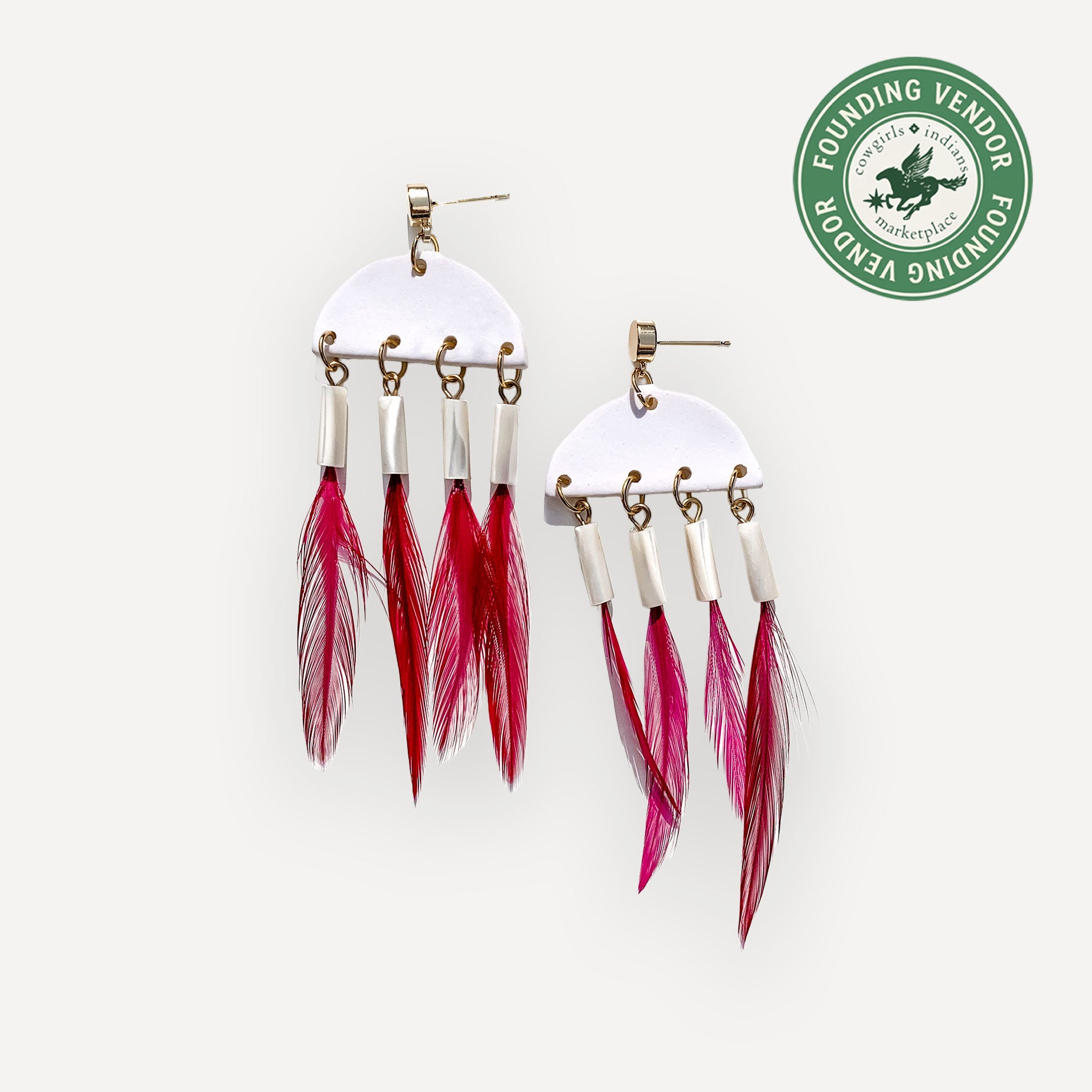 Clay cresent dangle earrings with feather fringe on white background