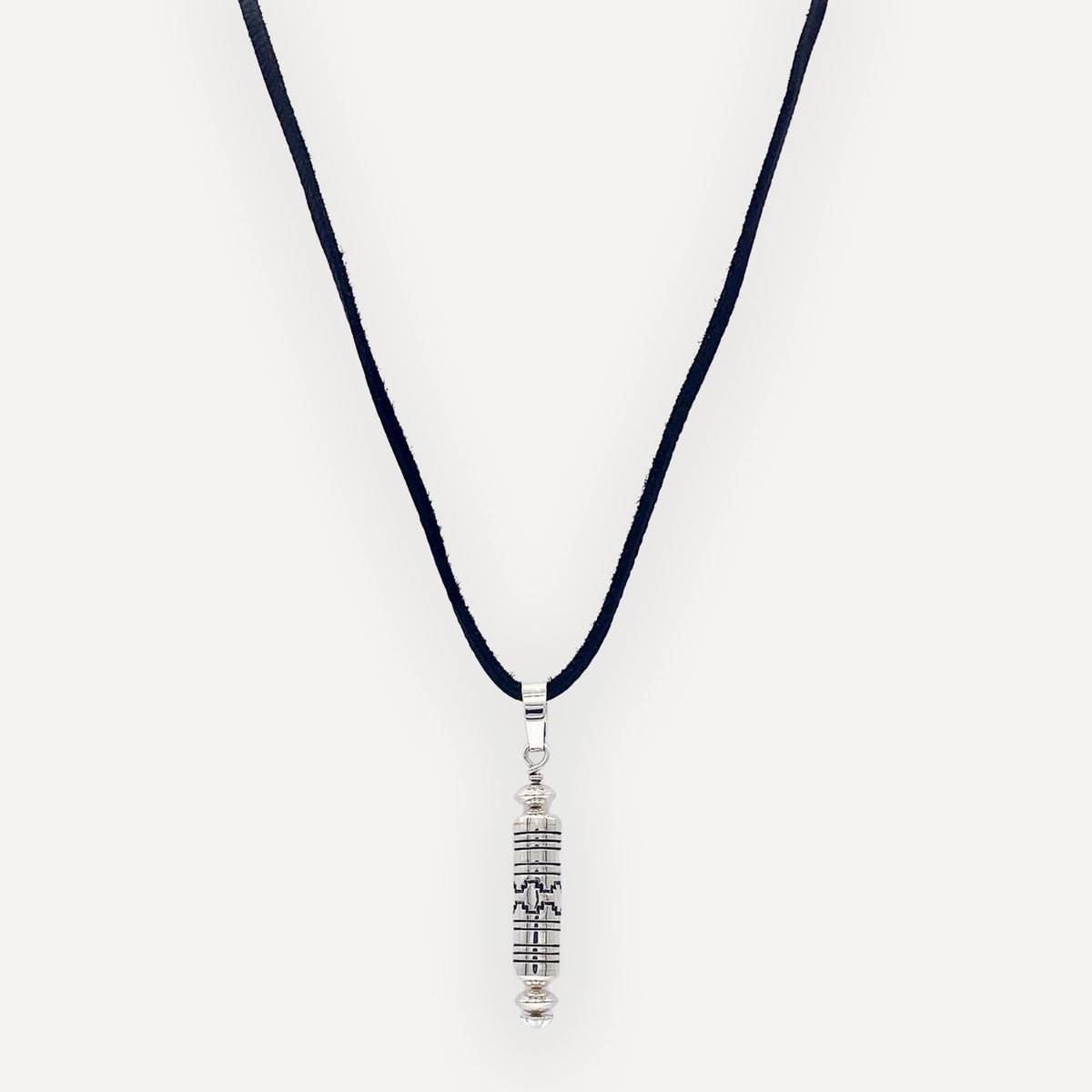 Sterling silver barrel bead pendant with a 360 degree stamped navajo mesa design and handmade navajo pearl beads on a white background