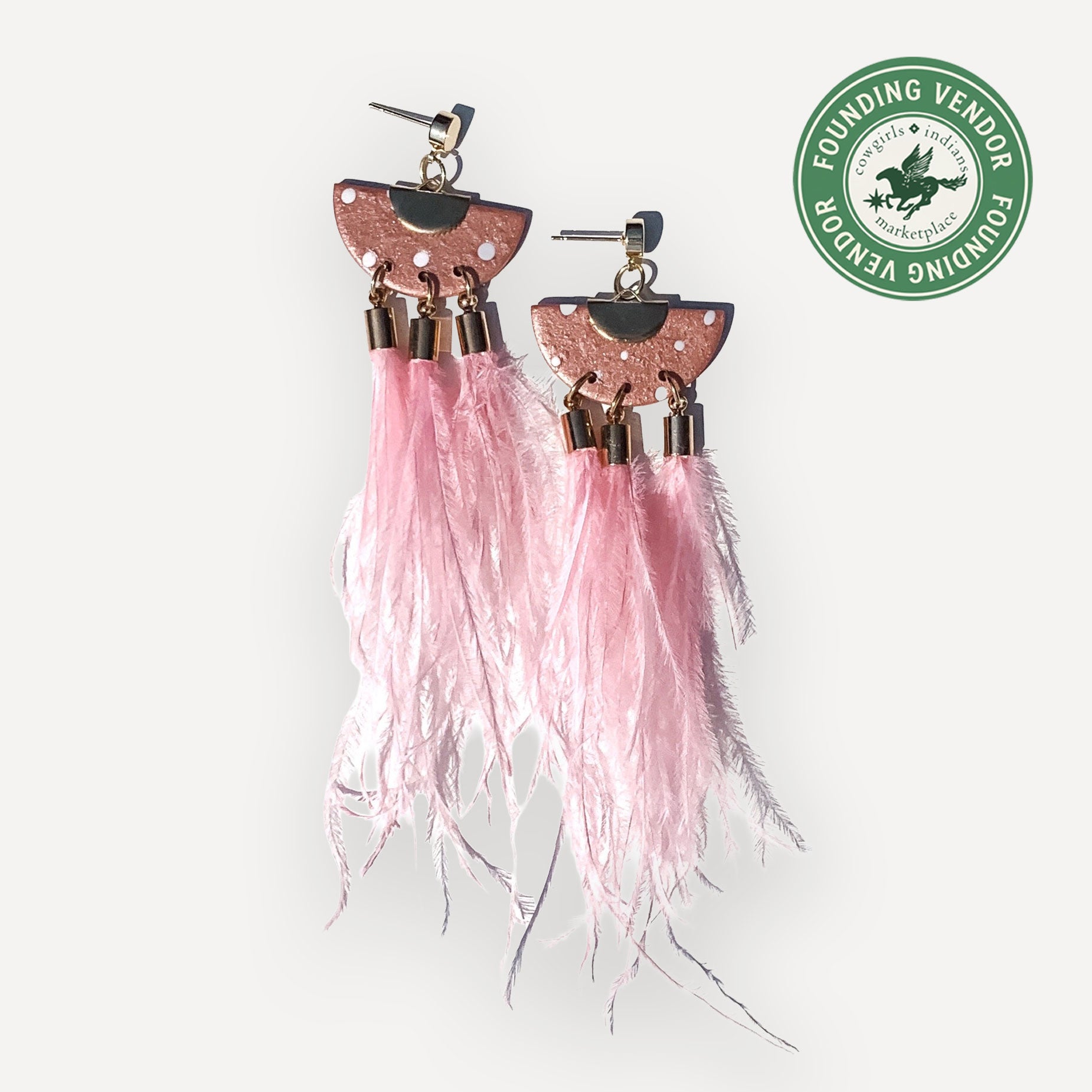 Pink feather earrings with metallic accents on a white background, featuring a Founding Vendor logo.