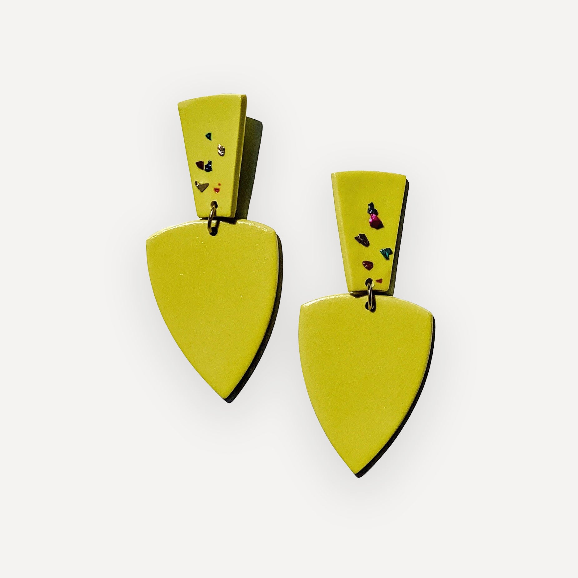 Pair of chartreuse earrings with black accents on a white background