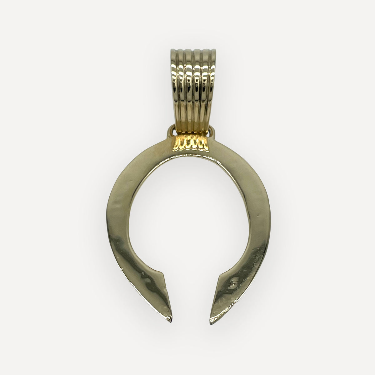 Solid 18 karat gold gothic naja pendant laying flat, detail of the hand-chiseled ingot bail