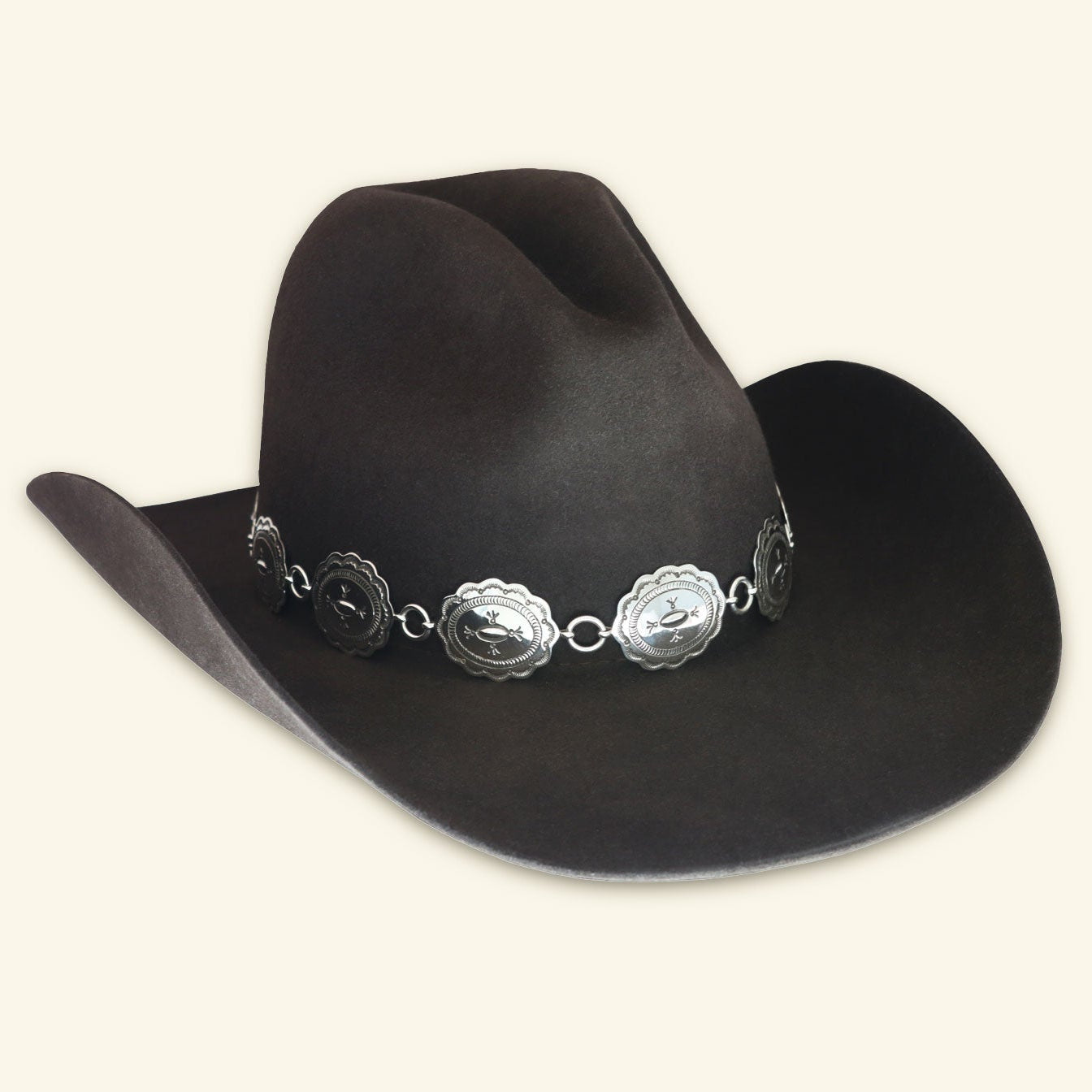 The Texas Flood hatband, with its distinctive Navajo stamped oval sterling silver conchos, displayed prominently on a classic dark felt cowboy hat.