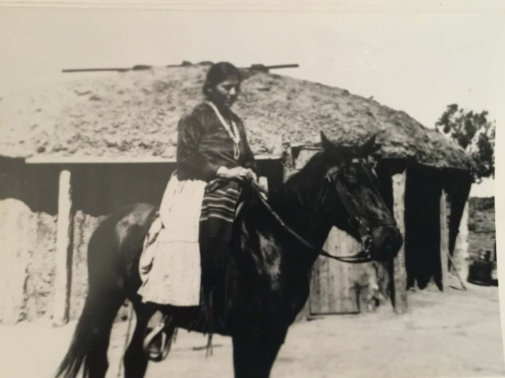Navajo woman on a black horse on the Navajo Reservation. 