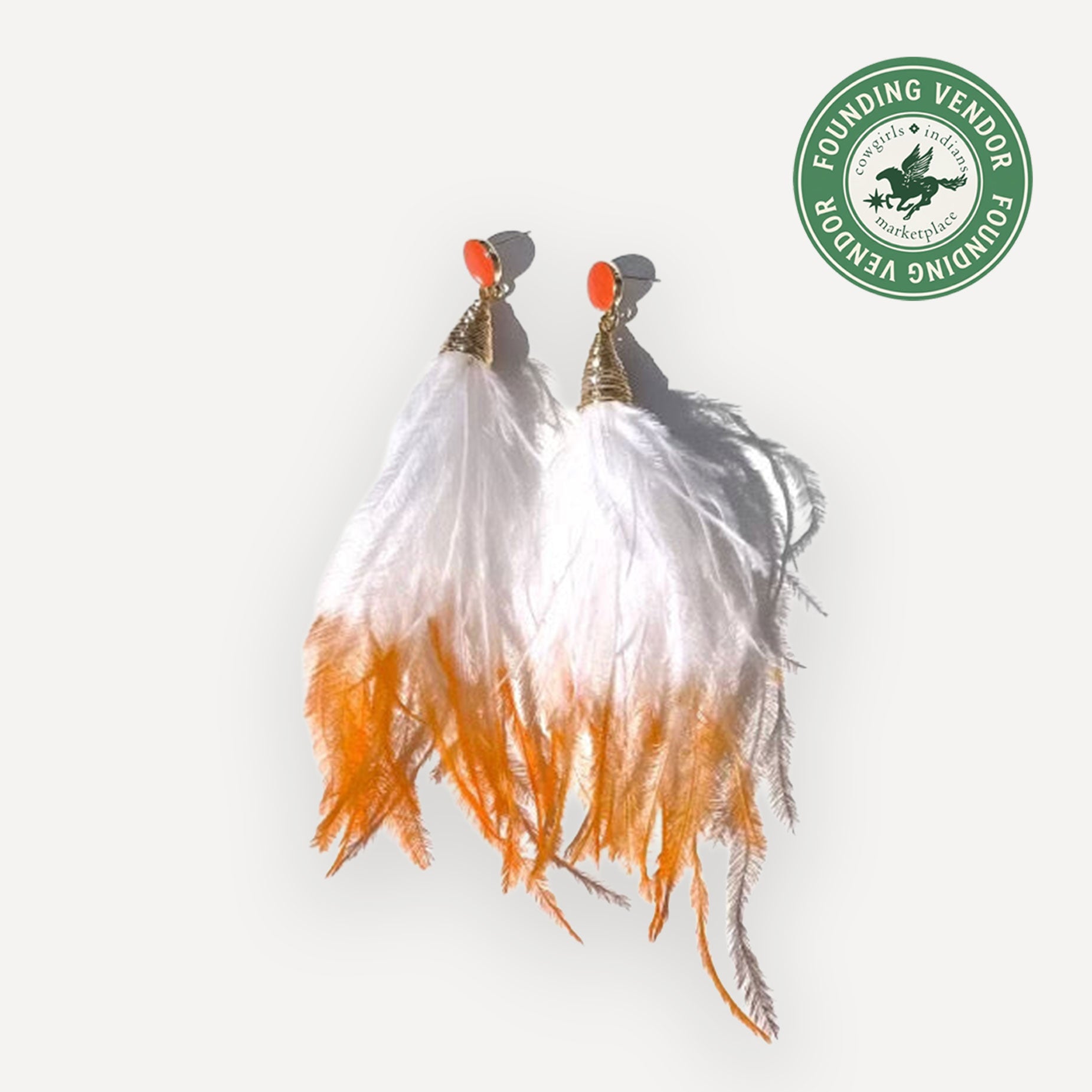 Ostrich Feather earrings in orange crush on white background