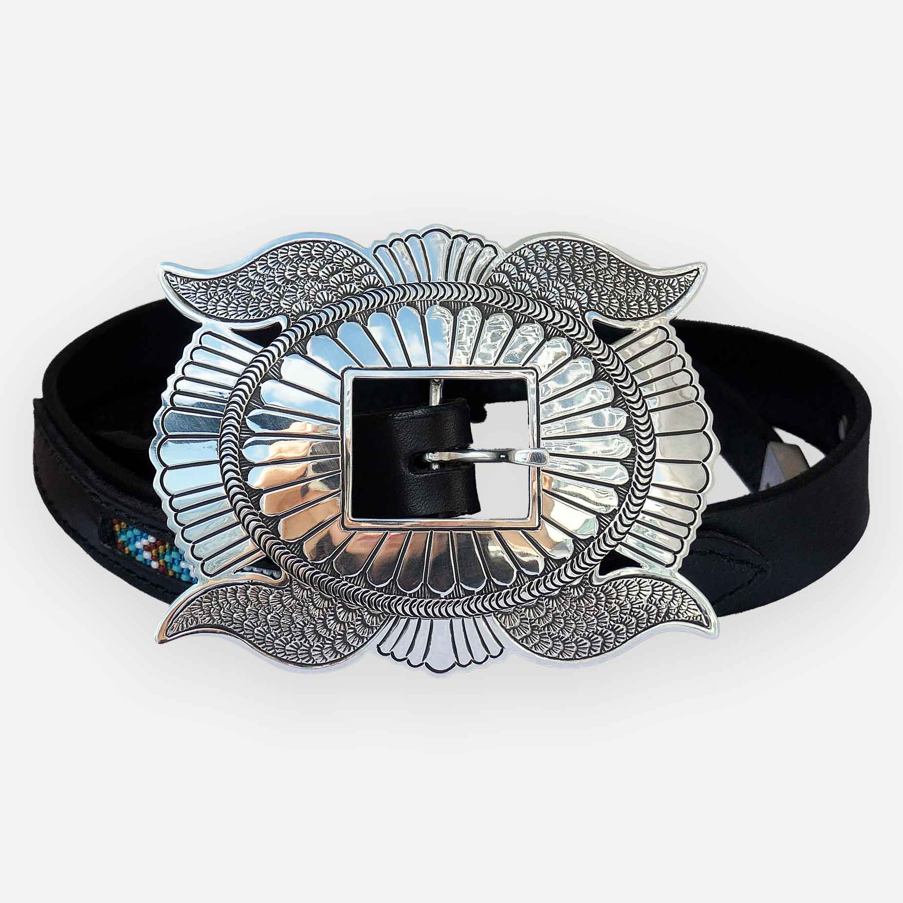 A black leather belt with a Navajo Butterfly Concho belt buckle in the center. 