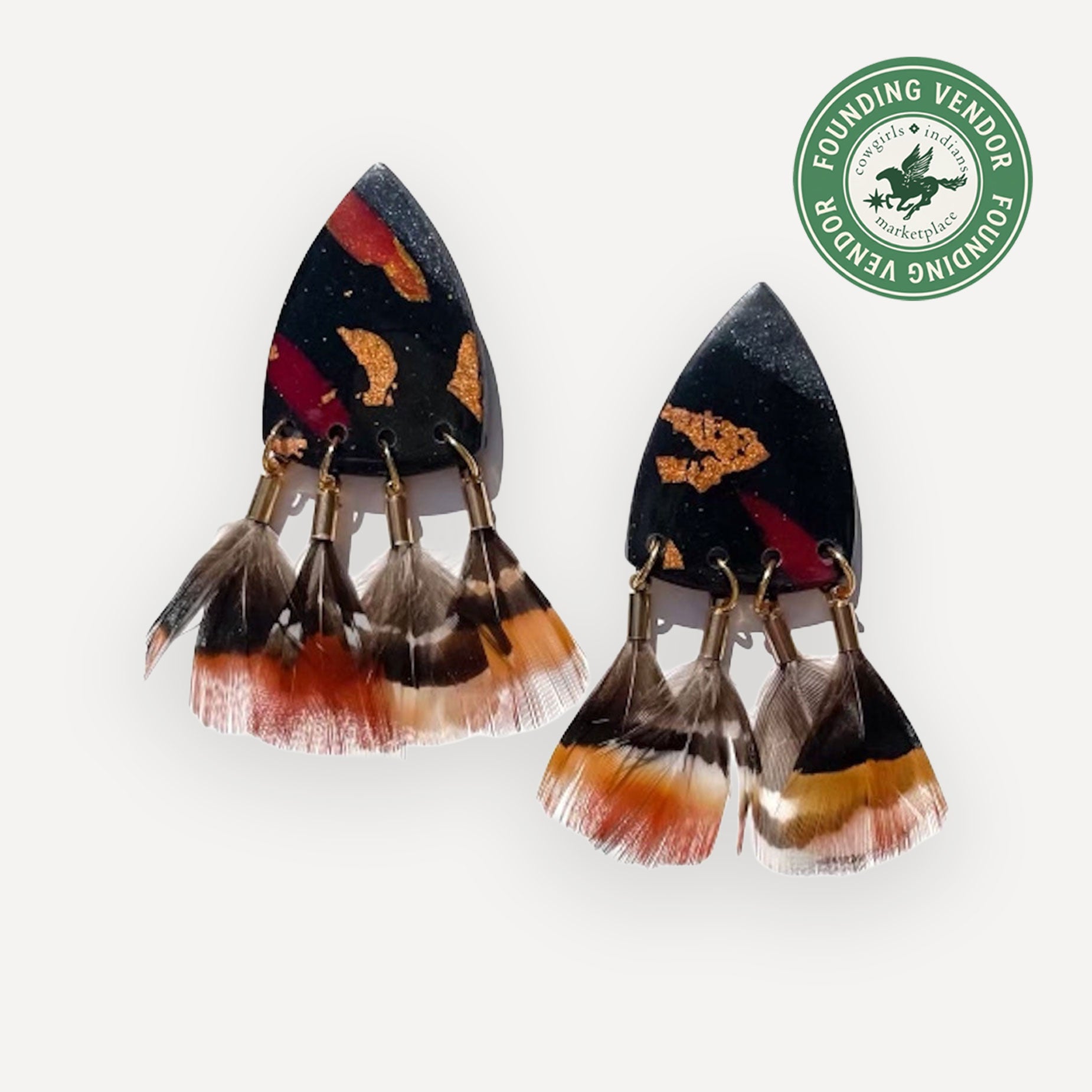 Pair of feather and ceramic earrings on white background